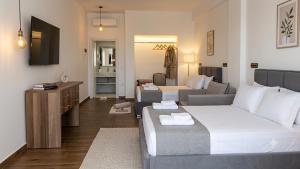 a living room with a bed and a couch at Grecia's Dhermi in Dhërmi