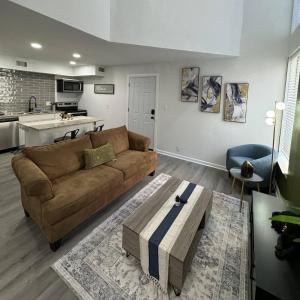 a living room with a brown couch and a kitchen at BR Dallas I6 in Dallas +37 photos
