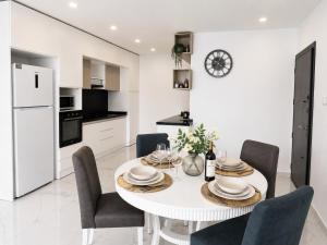 a kitchen and dining room with a white table and chairs at Blue life Long beach in Iskele +7 photos