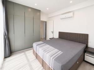 a bedroom with a large bed and white walls at Blue life Long beach in Iskele