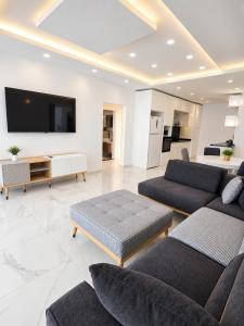 a living room with couches and a flat screen tv at Blue life Long beach in Iskele
