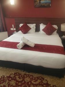 a large bed in a hotel room with two towels on it at Hidden Gem With Accomodation, Restaurant, Bar & Spa in Nairobi