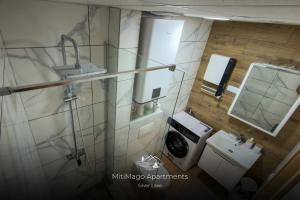 a small bathroom with a sink and a washing machine at Miti Apartment with Marina View & Spa Access in Veliko Gradište +7 photos