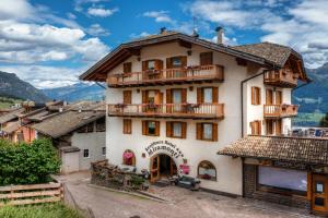 a large white building with a balcony at Residence Miramonti in Daiano