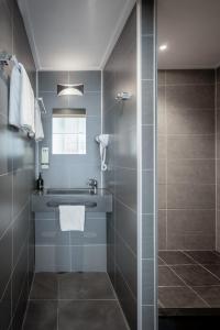 a bathroom with a sink and a shower at Hotel Library Amsterdam in Amsterdam +32 photos