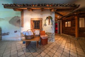 a room with a table and a wall with a mural at Residence Miramonti in Daiano