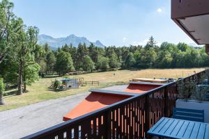 a balcony with a bench and a view of a field at Mille100-47 - Ubaye Base Camp in Faucon-de-Barcelonnette