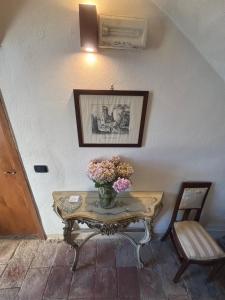 a table with a vase of flowers on it at Guest House Villa Castello in Nucetto +33 photos