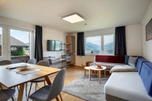 a living room with a couch and a table at Ferienwohnungen Tiroler Alpenhof in Innsbruck