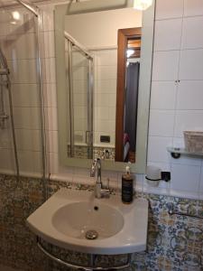 a bathroom with a sink and a mirror at B&B Dimora D'Alfano in SantʼAngelo in Pontano +14 photos