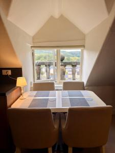 a table and chairs in a room with a window at Bagshaw Hall in Bakewell