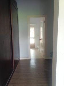 an empty room with a hallway with a toilet and a door at Bonanza in Ban Khanong Phra Klang (1)