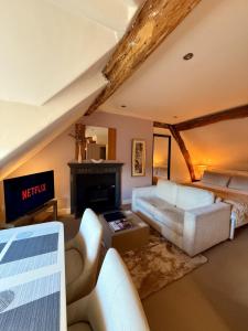 a living room with a couch and a fireplace at Bagshaw Hall in Bakewell