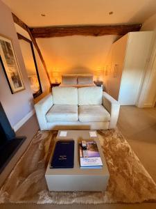 a living room with a couch and a table at Bagshaw Hall in Bakewell