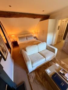 a living room with a bed and a couch at Bagshaw Hall in Bakewell +259 photos