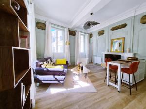 a living room with a couch and a table at Le 17eme - Centre Historique in Auch