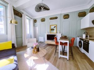 a living room with a couch and a table at Le 17eme - Centre Historique in Auch +7 photos