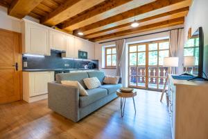 a living room with a couch and a kitchen at Apartmány Jezerné in Velké Karlovice
