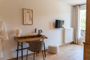 a room with a desk with a chair and a sink at Mille100-47 - Ubaye Base Camp in Faucon-de-Barcelonnette