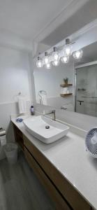 a white bathroom with a sink and a mirror at Banyan Beach House Villa in Bridgetown +43 photos