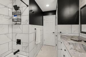 a white bathroom with a shower and a sink at New! Cozy Family Getaway: Amish Farmland|Patio|Washer & Dryer|Central Lancaster County in Ronks +28 photos