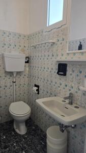 a bathroom with a toilet and a sink at Hotel Marittimo in Rimini +168 photos