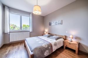 a bedroom with a bed and a window at Gîte Du Noiret in Cruseilles