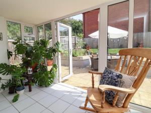 a porch with a rocking chair and a patio at Manning's View in Barnstaple