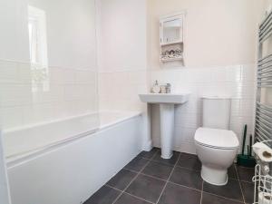 a bathroom with a toilet and a tub and a sink at Manning's View in Barnstaple +16 photos