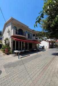 a building with tables and chairs in front of it at Miralya Downtown in Fethiye