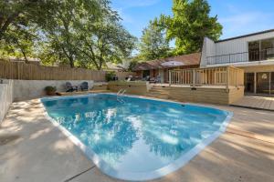 a swimming pool in the backyard of a house at Aspen Pool House- 1 Mile From OU in Norman