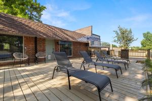 a group of chairs sitting on a deck at Aspen Pool House- 1 Mile From OU in Norman