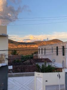 a view of a white building with a fence at Quarto Alecrim in Ibicoara
