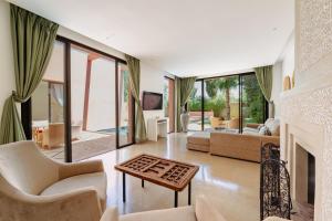 a living room filled with furniture and a fireplace at Al Maaden Villa Hotel & Spa in Marrakesh