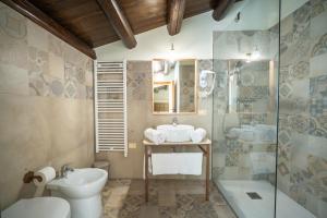 a bathroom with a sink and a toilet and a shower at ChocoHouse in Ragusa