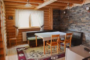 a dining room with a table and two chairs at Будиночок улюблений in Shirokoye
