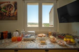 a kitchen counter with food on it with a window at ChocoHouse in Ragusa +35 photos