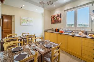 a kitchen and dining room with tables and chairs at ChocoHouse in Ragusa
