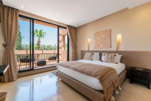 a bedroom with a large bed and a balcony at Al Maaden Villa Hotel & Spa in Marrakesh +148 photos