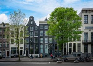 a large black and white building on a city street at Hotel Library Amsterdam in Amsterdam