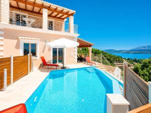 a villa with a swimming pool with a view at Villa Frosso in Kalami