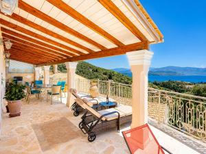 a patio with a table and chairs on a balcony at Villa Frosso in Kalami