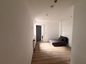 a hallway with a couch in a white room at PaderQuartier2 in Paderborn
