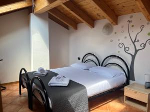 a bedroom with a bed with a tree mural on the wall at Casa Miravalle Mountain Apartments in Enguiso