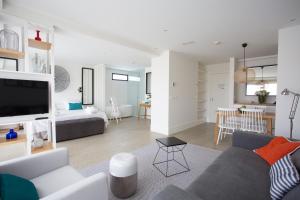 a living room with a couch and a room with a bed at Hotel Almirante in Alicante