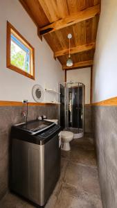 a bathroom with a sink and a toilet at Tiny house in Coñaripe