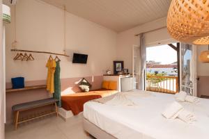 two beds in a room with a balcony at Filanthi - The project in Methoni