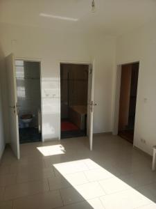 an empty bathroom with a toilet and a sink at Spacious Heritage Apartment for Groups in Bruck an der Leitha +1 photo
