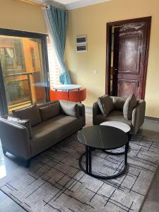 a living room with a couch and a table at Résidences Quezia in Libreville