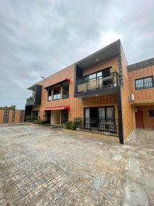 a brick building with a courtyard in front of it at Résidences Quezia in Libreville